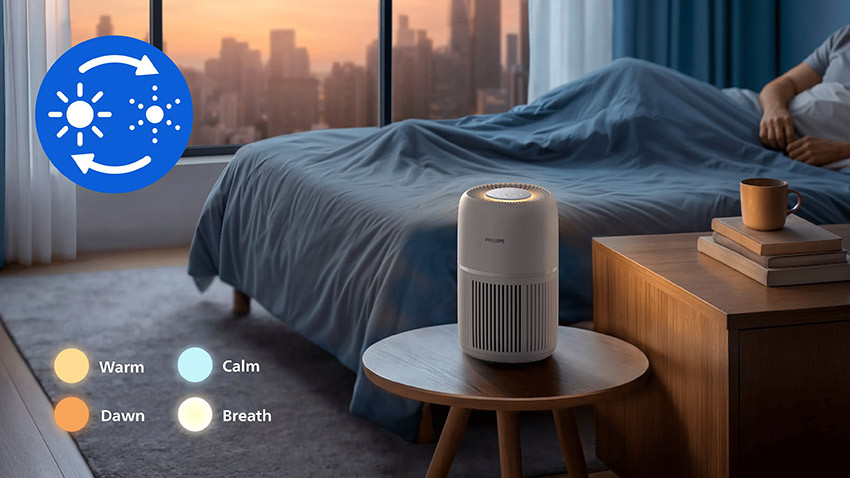 Philips AC0720/10 z włączonym ciepłym pierścieniem światła na stoliku w sypialni