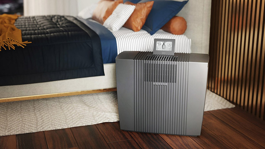 Venta Professional AW902 w szarej obudowie ustawiony na podłodze przed łóżkiem